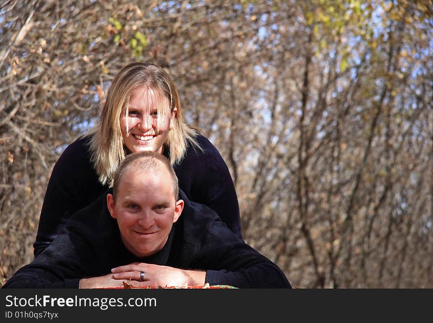 A happy young couple in the woods in Autumn. A happy young couple in the woods in Autumn