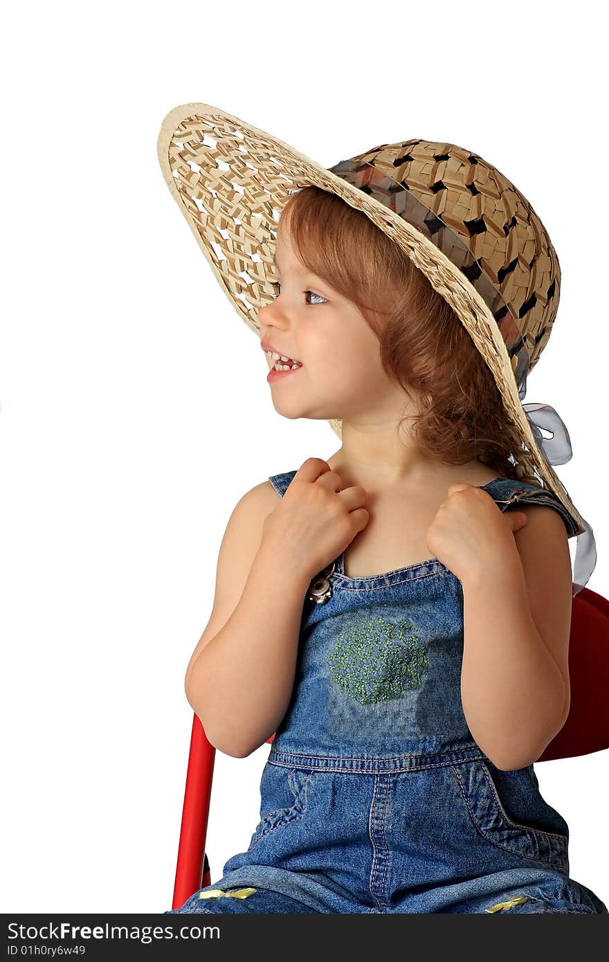 A little girl is in a straw hat. A little girl is in a straw hat.