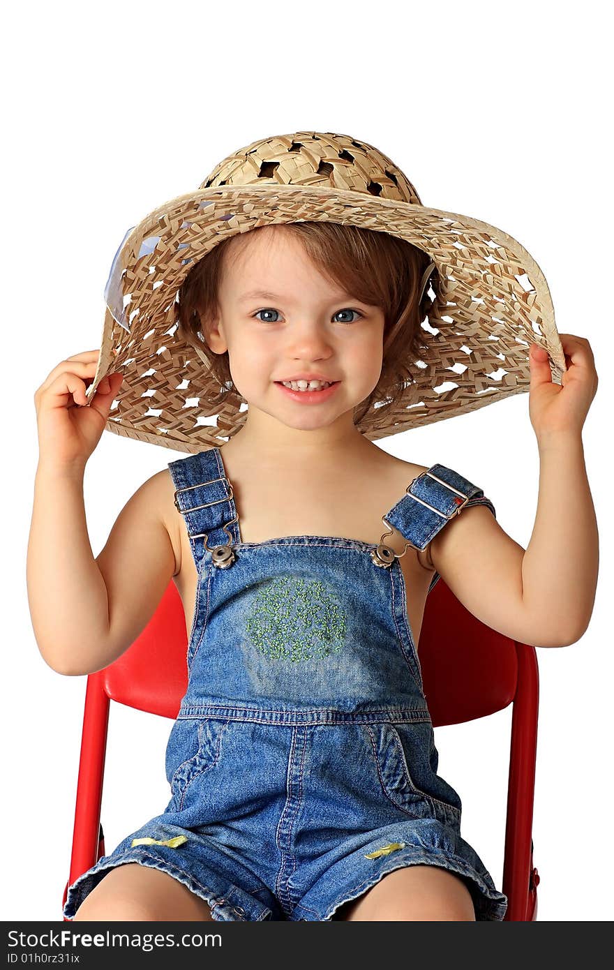 A little girl is in a straw hat. A little girl is in a straw hat.