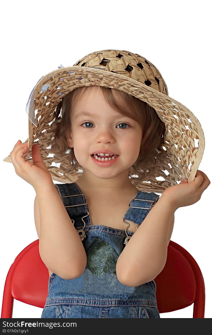 A little girl is in a straw hat. A little girl is in a straw hat.