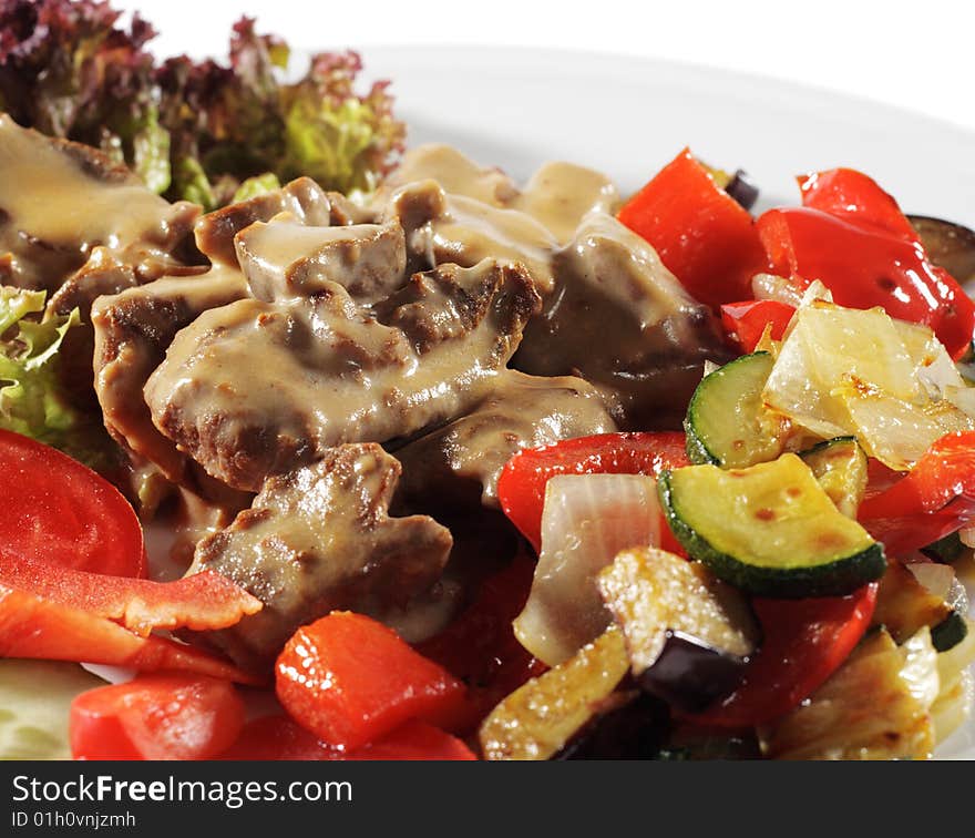 Stewed Beef with Vegetables and Fresh Vegetable on Plate