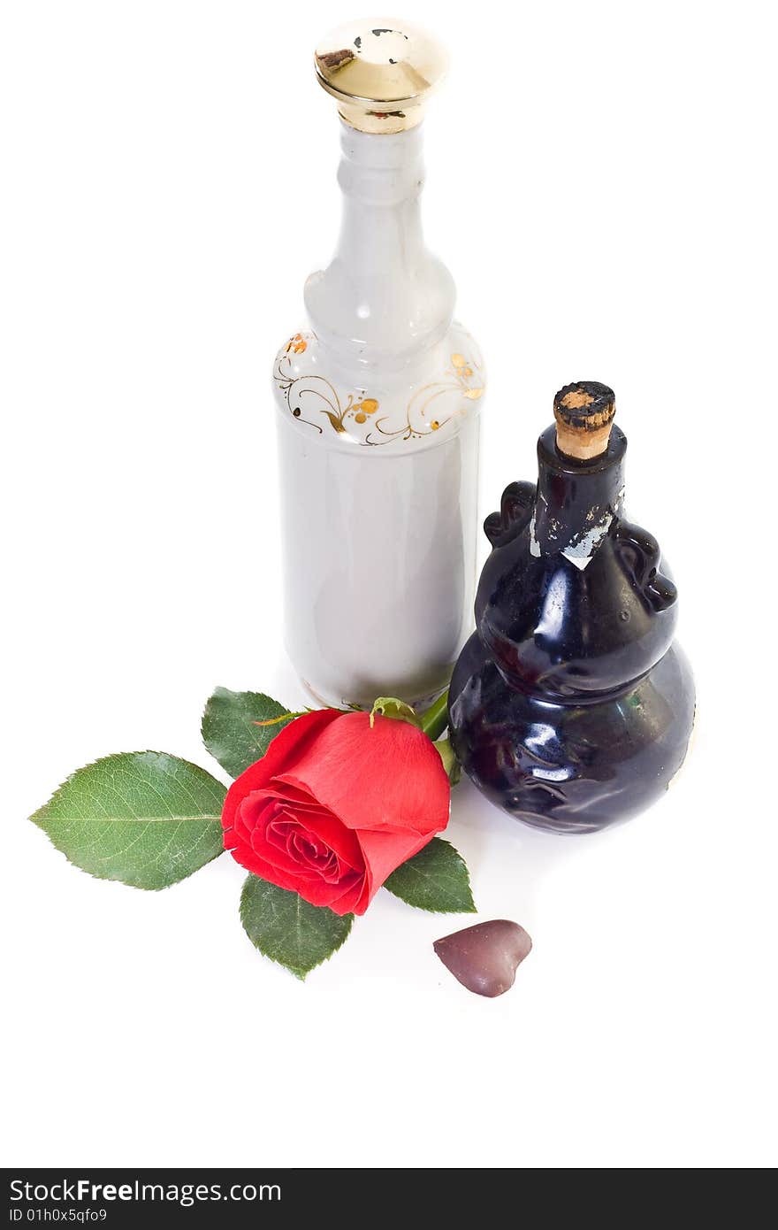 Still life with two bottles, red rose and chocolate heart. Still life with two bottles, red rose and chocolate heart