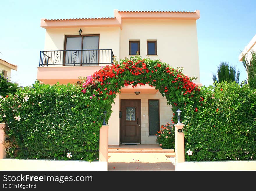 Beautiful house with flowers arch. Beautiful house with flowers arch.