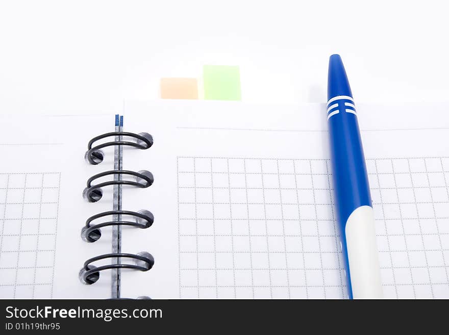 Blank notebook with pen on white background