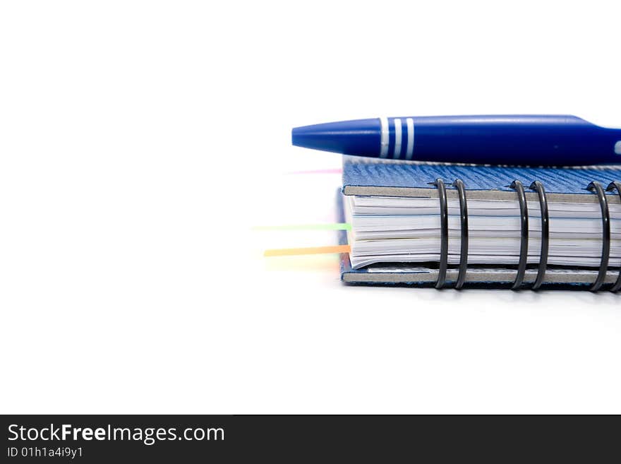 Blue notebook and blue pen isolated on white background