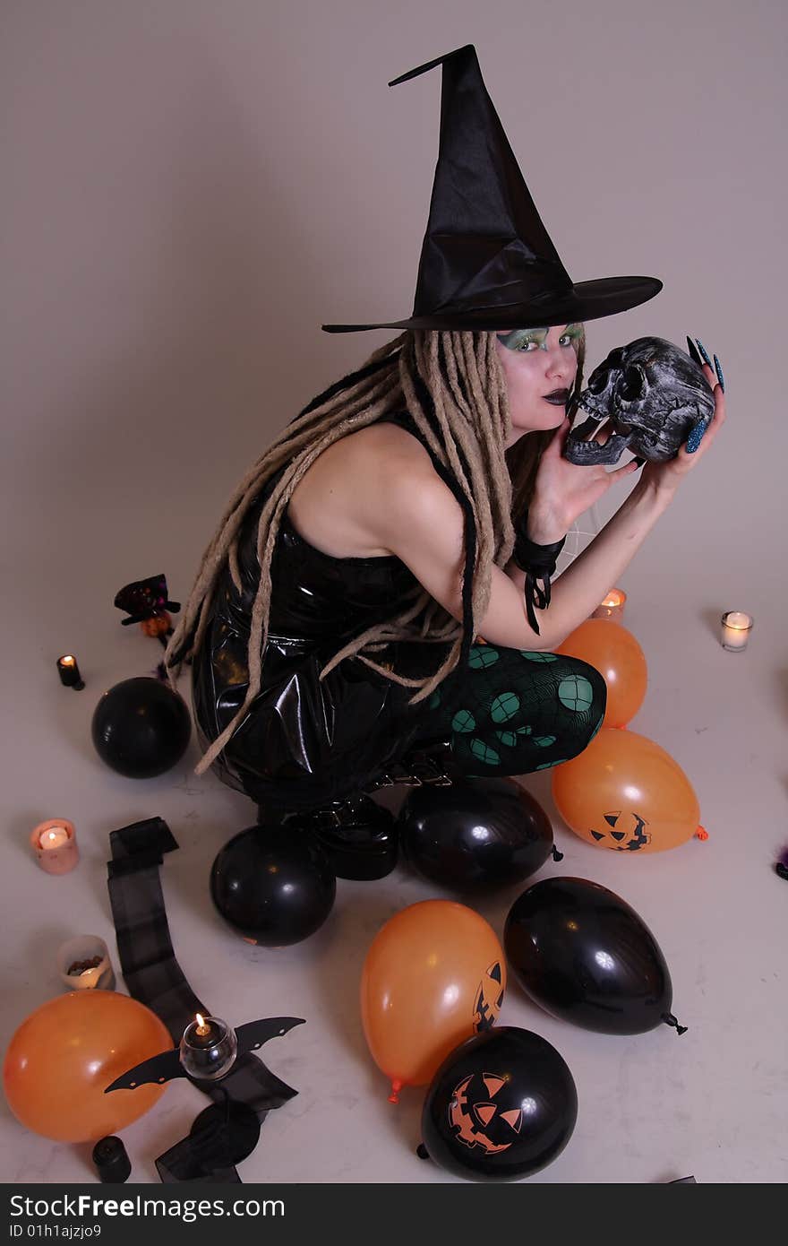 Young woman with pumpkin and Halloween setting