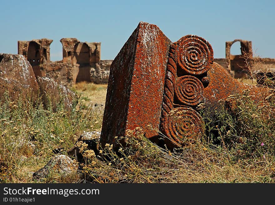 Antic fallen column in ruins of ancient Ani, Turkey. Detail of decorated head of column.