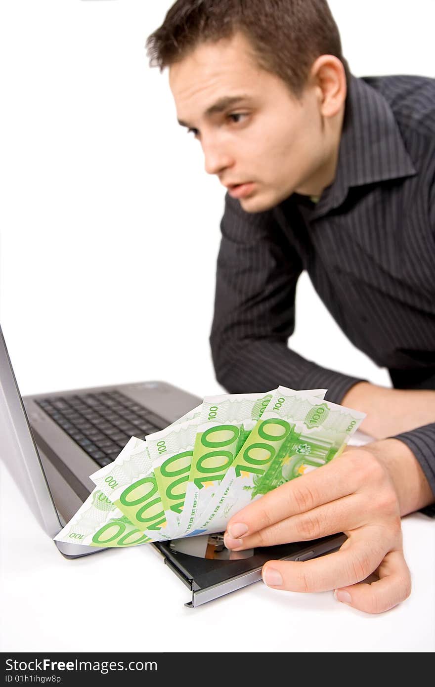 The businessman is sending the money on-line, in focus the money. The businessman is sending the money on-line, in focus the money