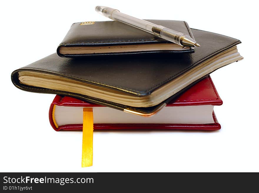 Three notebooks (organizers) and jell pen on isolated background. Three notebooks (organizers) and jell pen on isolated background.