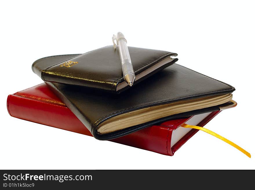 Three notebooks (organizers) and jell pen on isolated background. Three notebooks (organizers) and jell pen on isolated background.