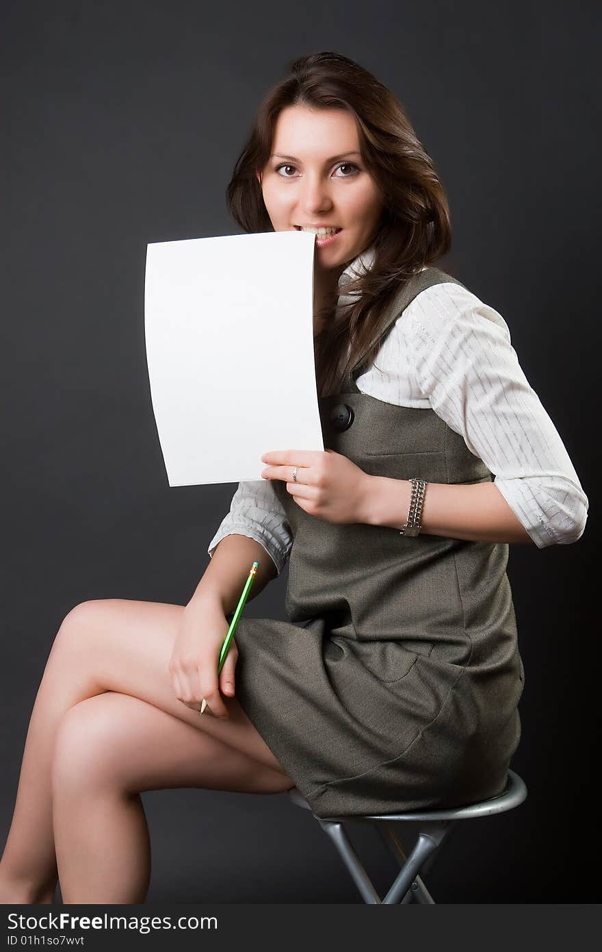 Pretty woman with a notebook against a dark background. Pretty woman with a notebook against a dark background