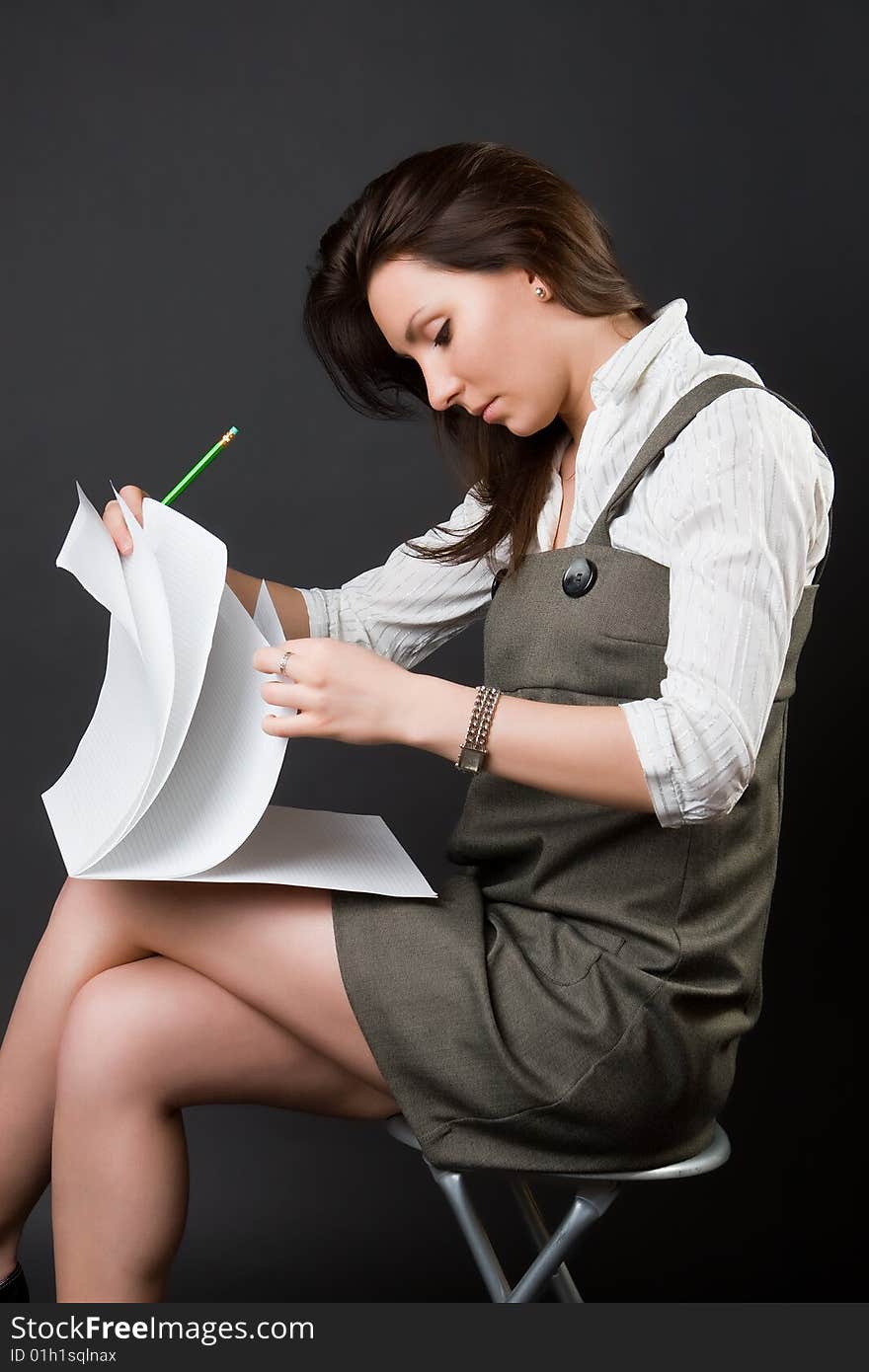 Pensive woman with a notebook against a dark background. Pensive woman with a notebook against a dark background