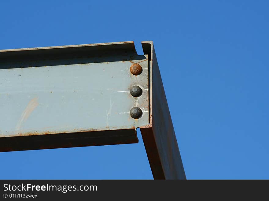 Girder and rivets against blue sky