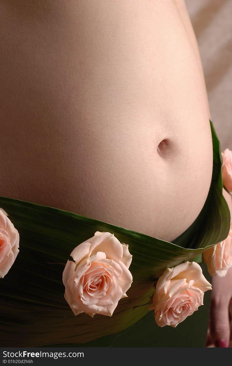 Pregnancy woman in the dressing made of a flowers. Pregnancy woman in the dressing made of a flowers