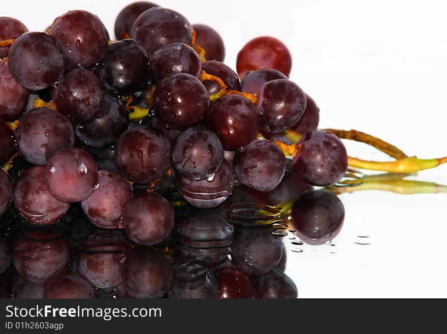 Cluster of pink grape isolated on white background