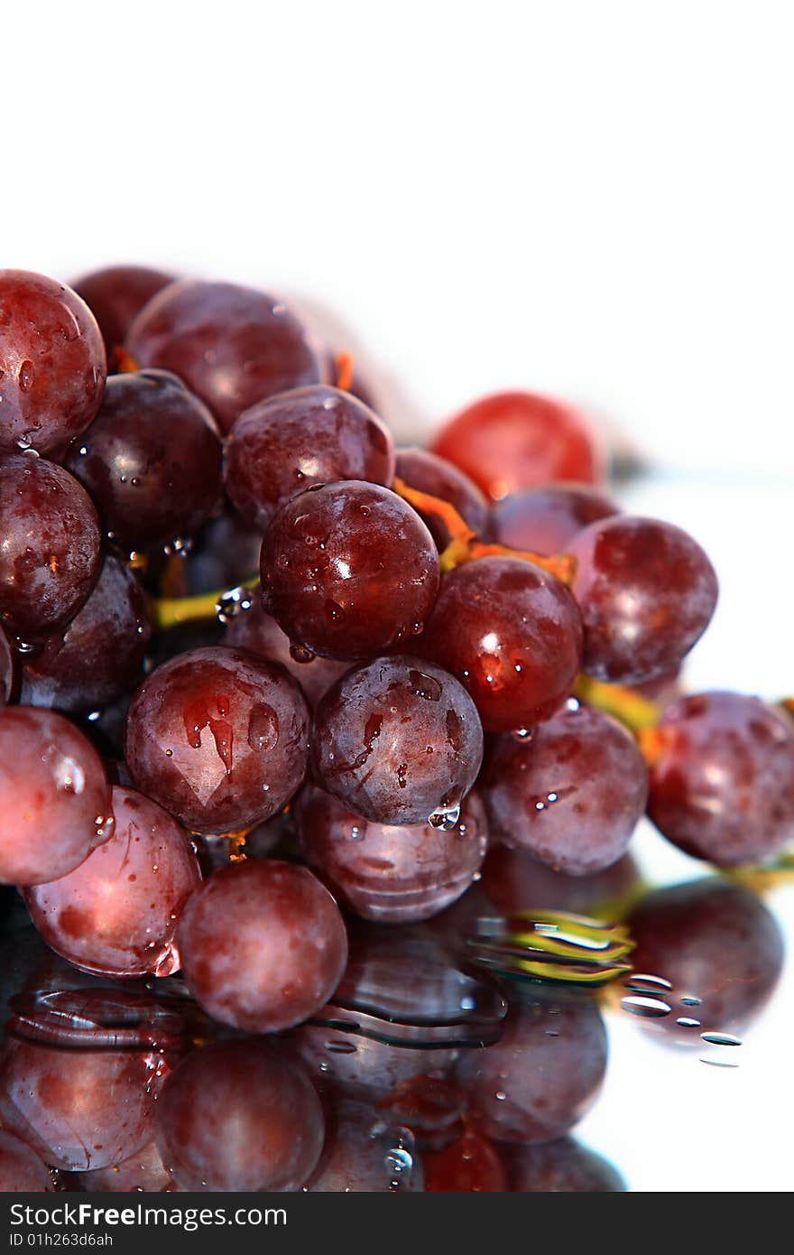 Cluster of pink grape isolated on white background