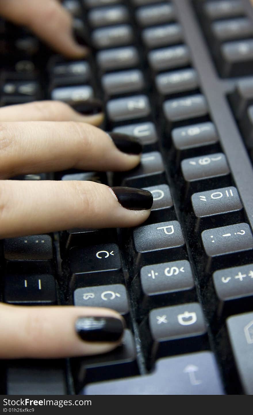 Computer keyboard and woman`s hands typing on it. Computer keyboard and woman`s hands typing on it.