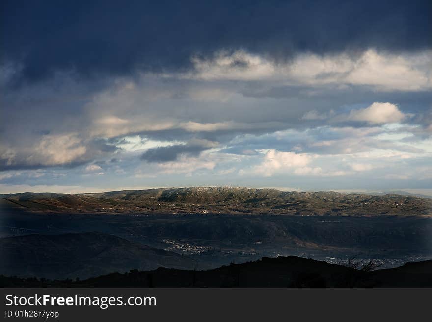 Snowy mountain landscape with tree in foreground