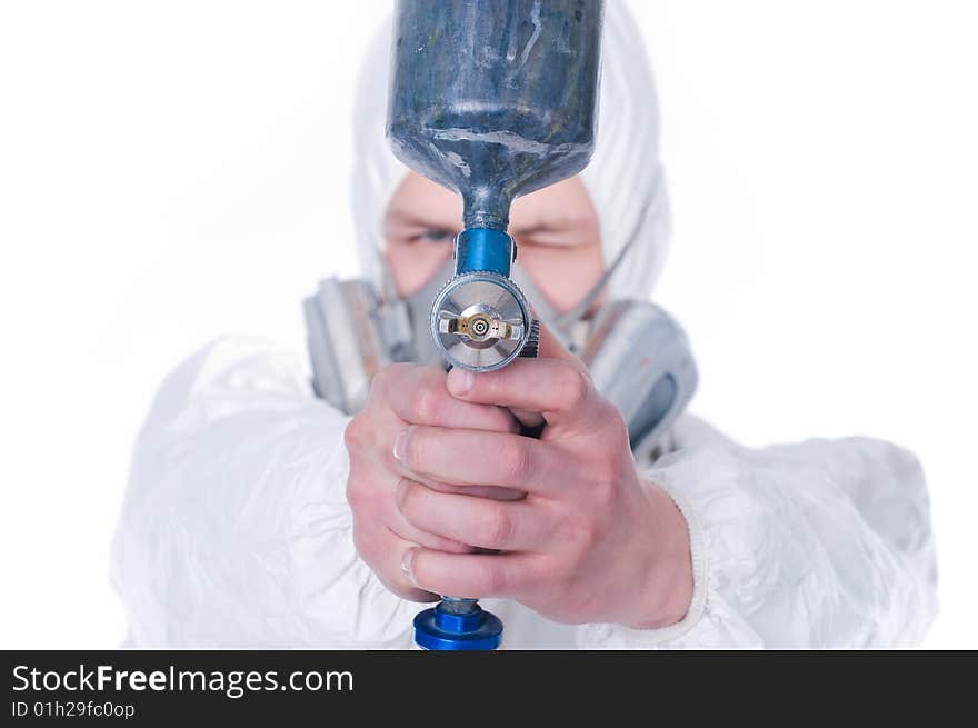 Man with airbrush gun, selective focus on gun