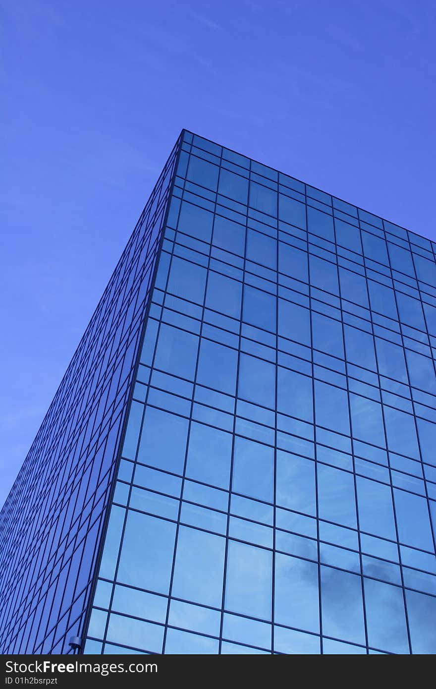 Modern glass office building of dark blue colour. Modern glass office building of dark blue colour