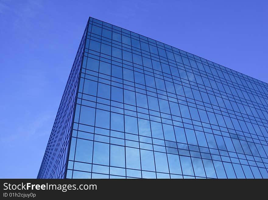 Modern glass office building of dark blue colour. Modern glass office building of dark blue colour