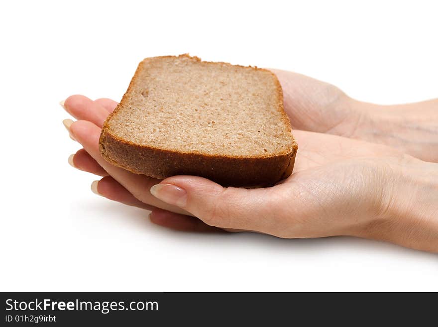 Piece of the pumpernickel in woman hands insulated on white background