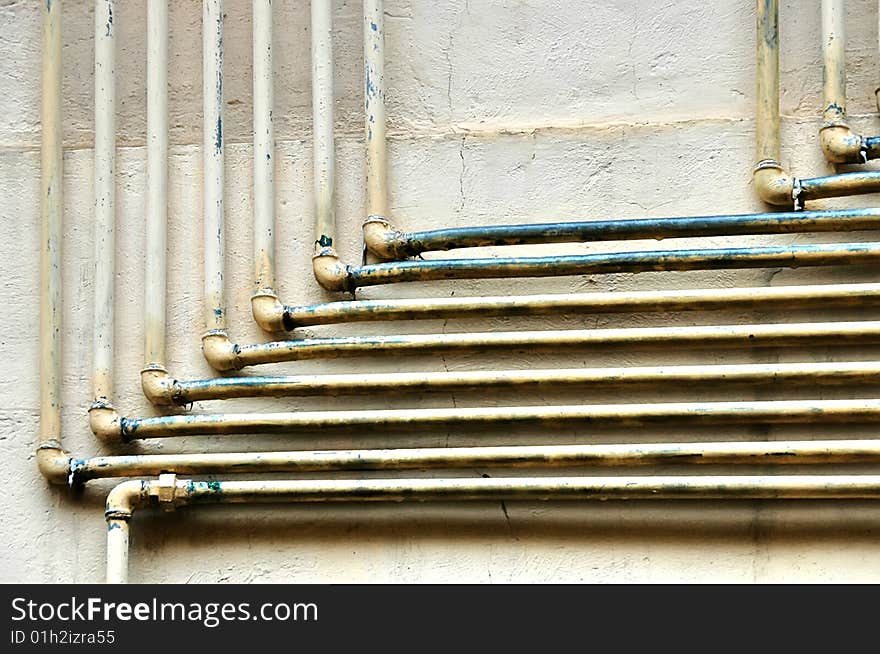 Old gas pipes over a wall. Old gas pipes over a wall