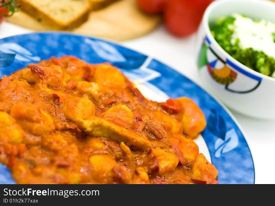 Slice of meat with dumplings-Gnocchi- and red bell pepper  sauce.