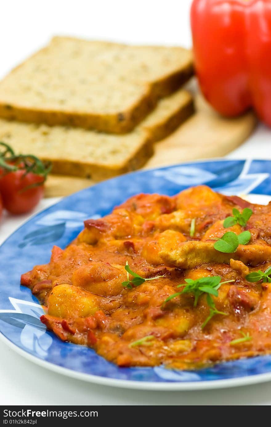 Slice of meat with dumplings-Gnocchi- and red bell pepper  sauce.