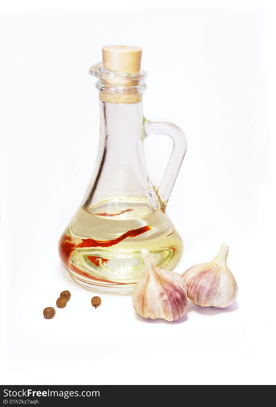 Still life with oil garlic and spices on a white background