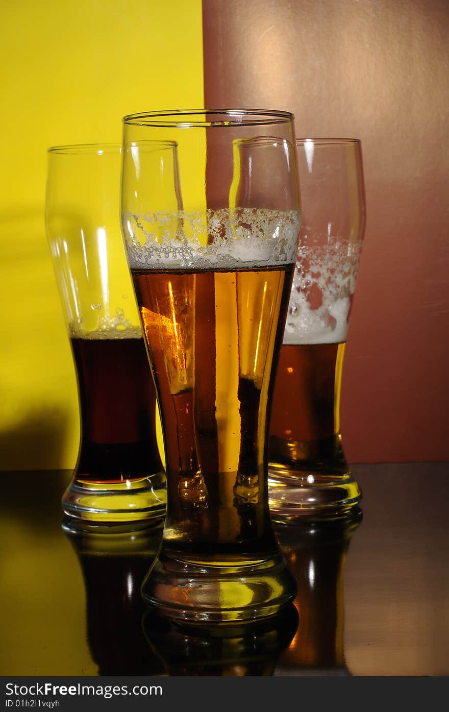 Three glasses with light and dark beer. Three glasses with light and dark beer