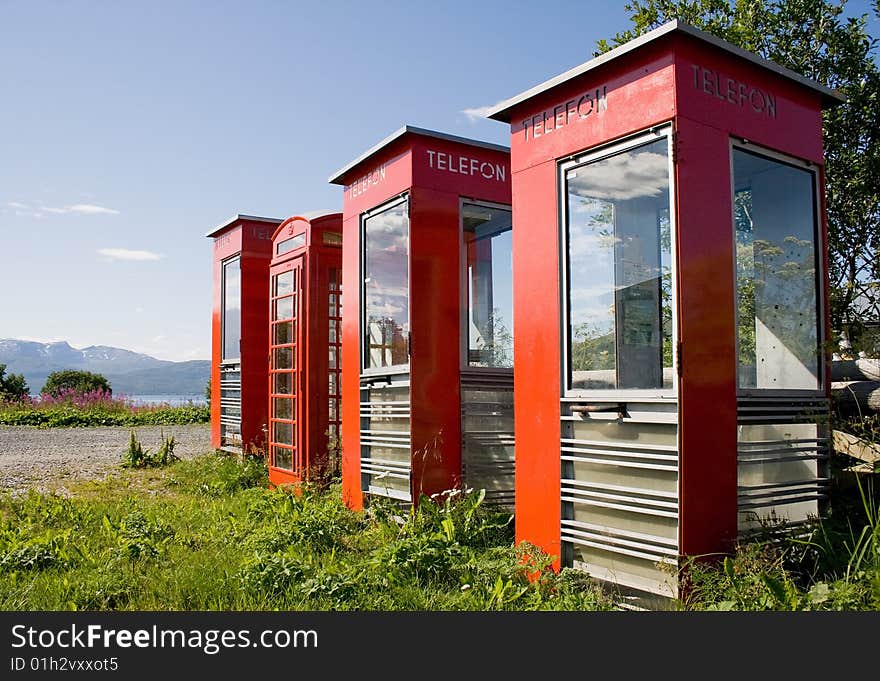 Four old telephone boxes on  non-urban  background