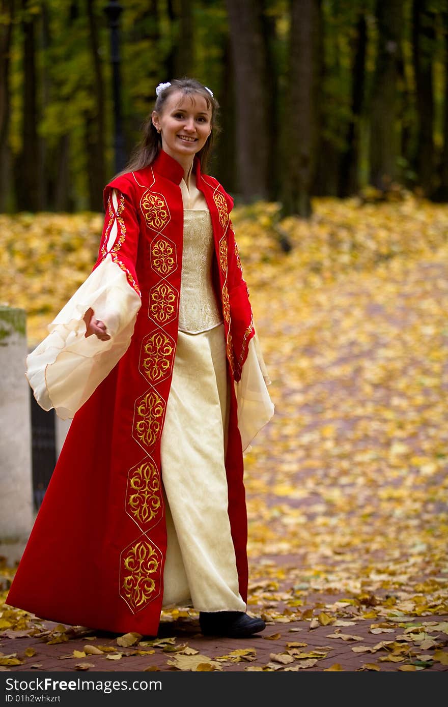 Lady in medieval red dress in the autumn forest. Lady in medieval red dress in the autumn forest