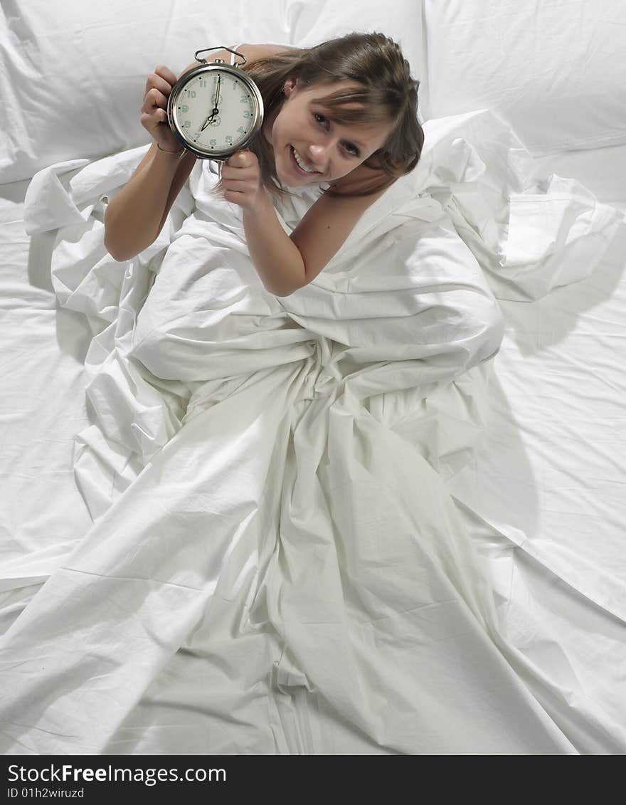 Woman in bed with alarm clock. Woman in bed with alarm clock