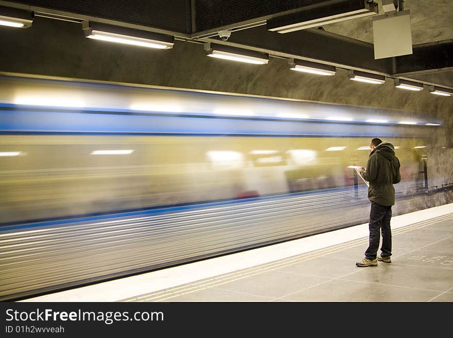 Fast train passing by. motion blur. man reading newspaper. Fast train passing by. motion blur. man reading newspaper