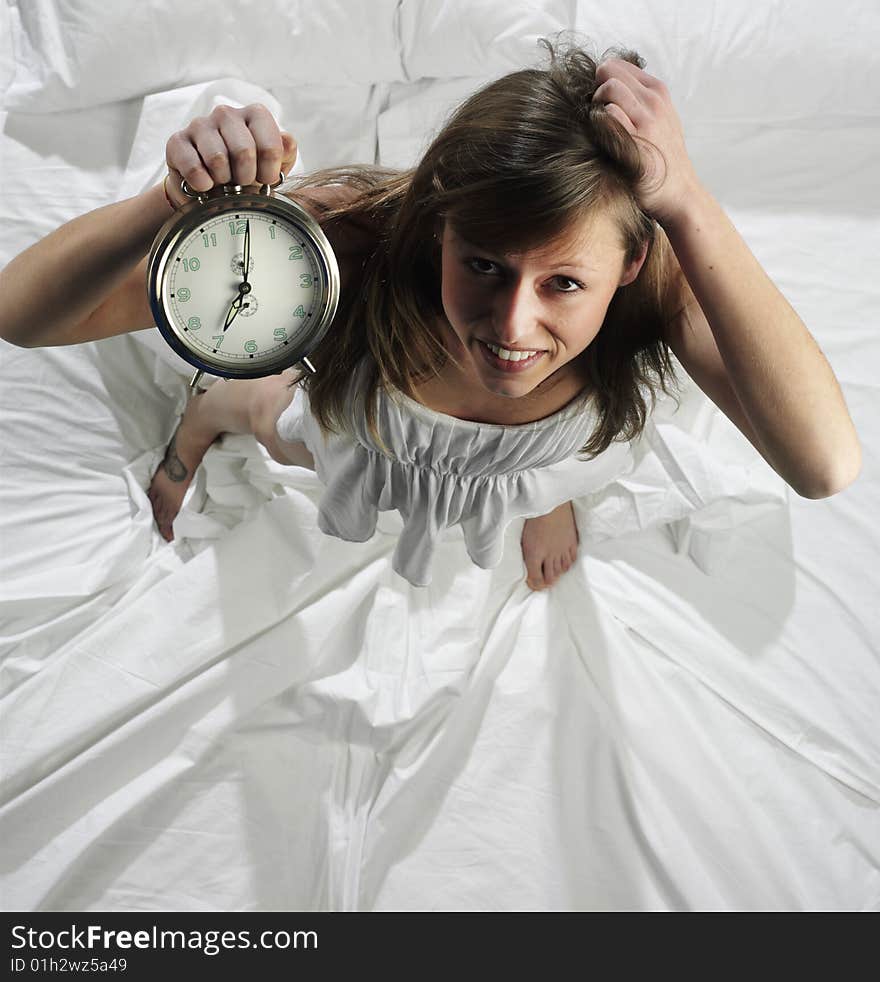 Woman in bed with alarm clock. Woman in bed with alarm clock