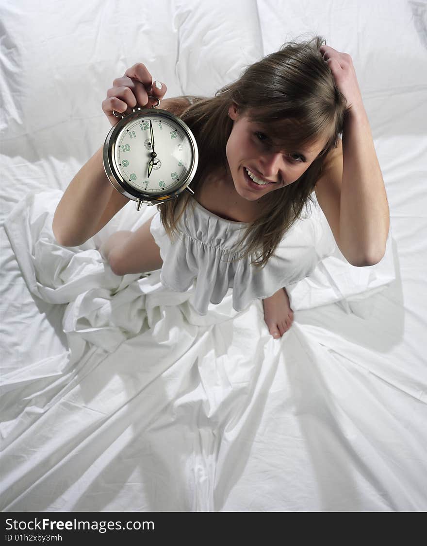 Woman in bed with alarm clock. Woman in bed with alarm clock