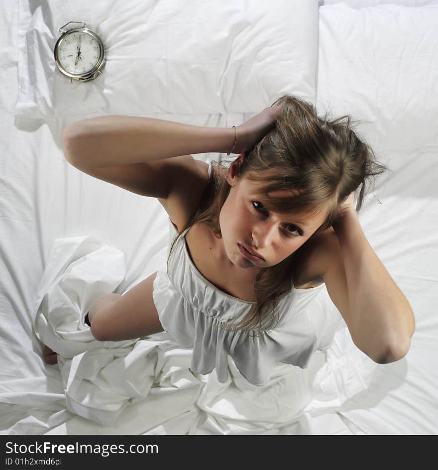 Woman in bed with alarm clock. Woman in bed with alarm clock