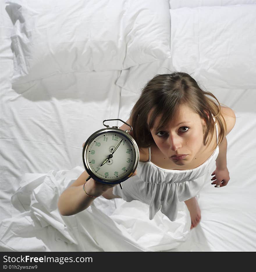 Woman in bed with alarm clock. Woman in bed with alarm clock