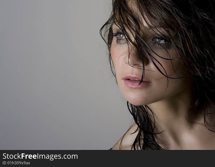 Close-up portrait of beautiful wet brunette