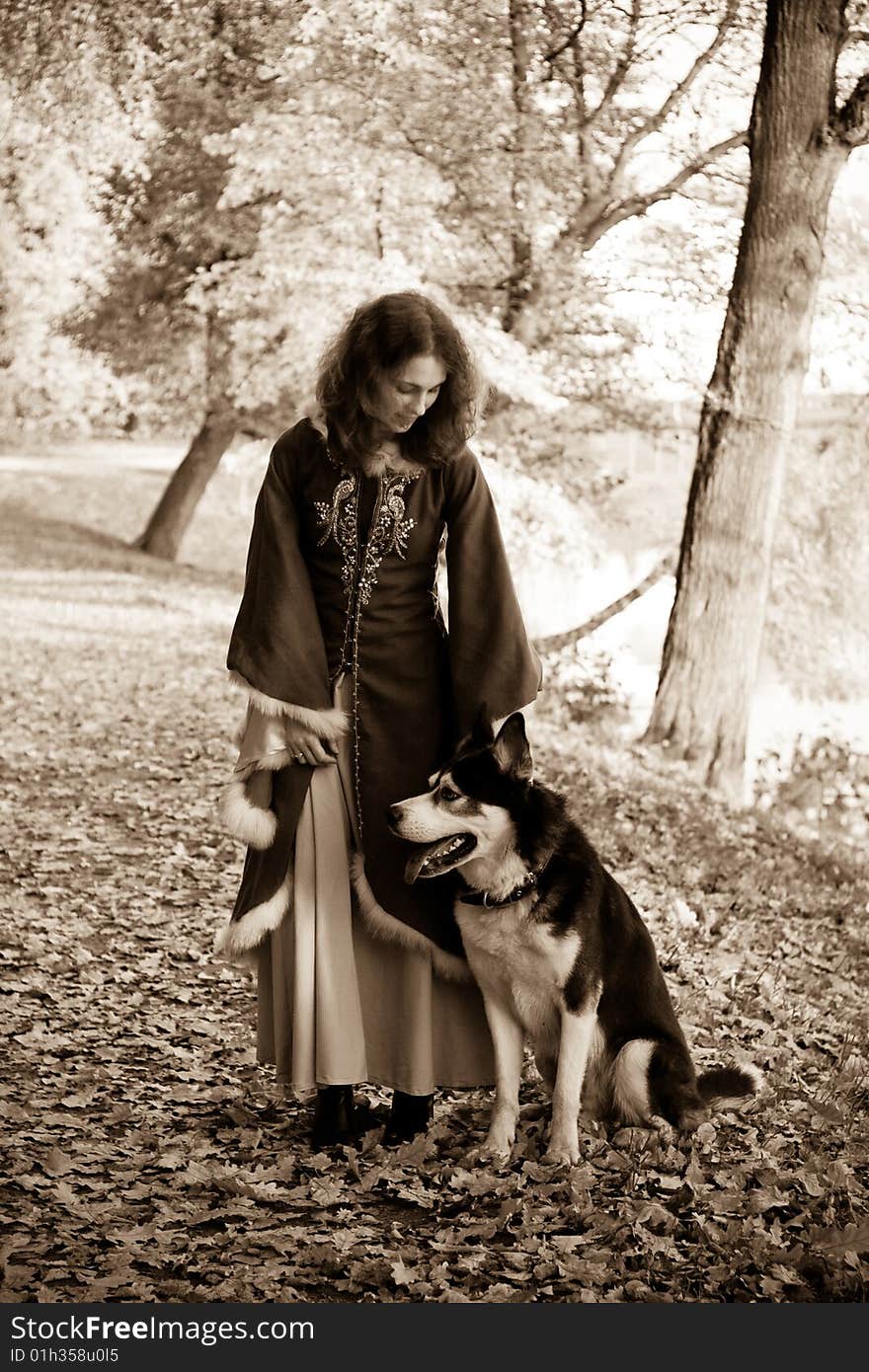 Lady in medieval dress and dog in the forest. Lady in medieval dress and dog in the forest