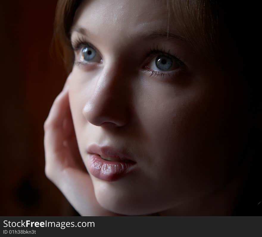 Portrait of the girl in a dark tonality on a dark background