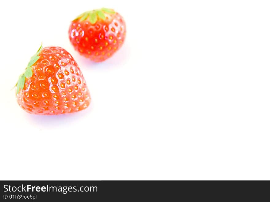 High key image of two strrawberries with a shallow dof on a white background. High key image of two strrawberries with a shallow dof on a white background