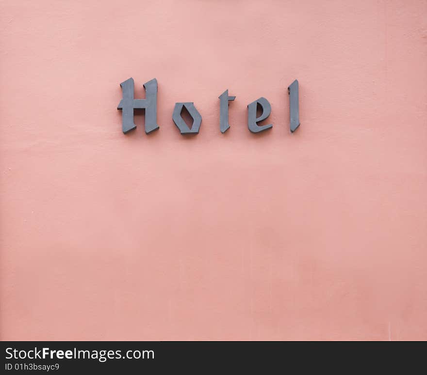 Hotel sign and old wall