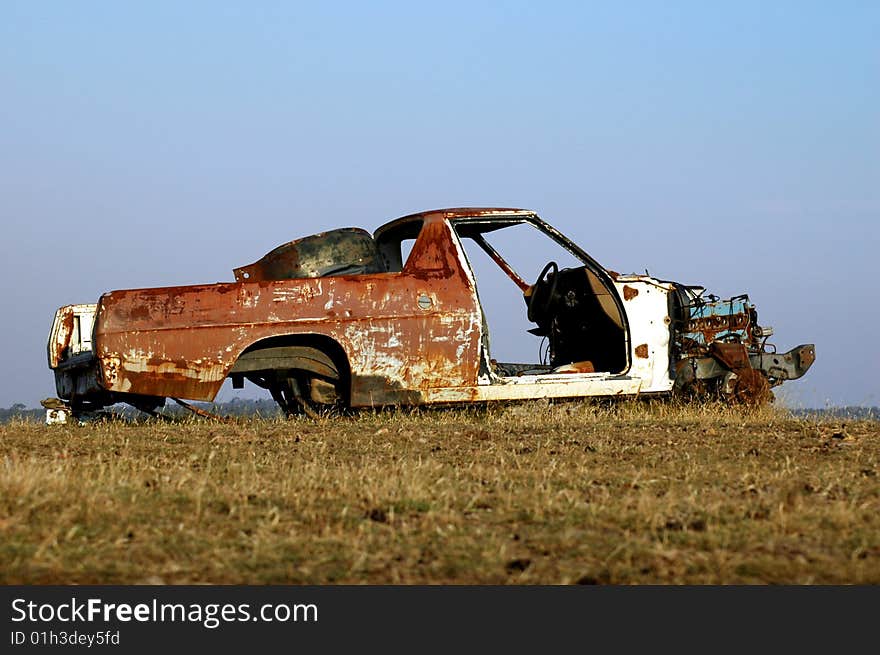 Abandoned car left in a field