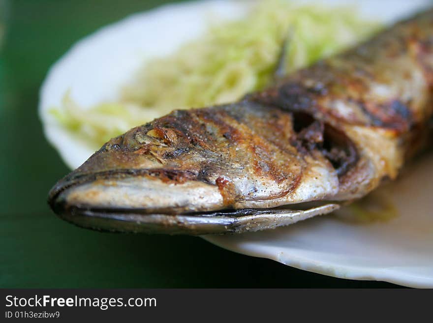 Grilled fish on a plate.