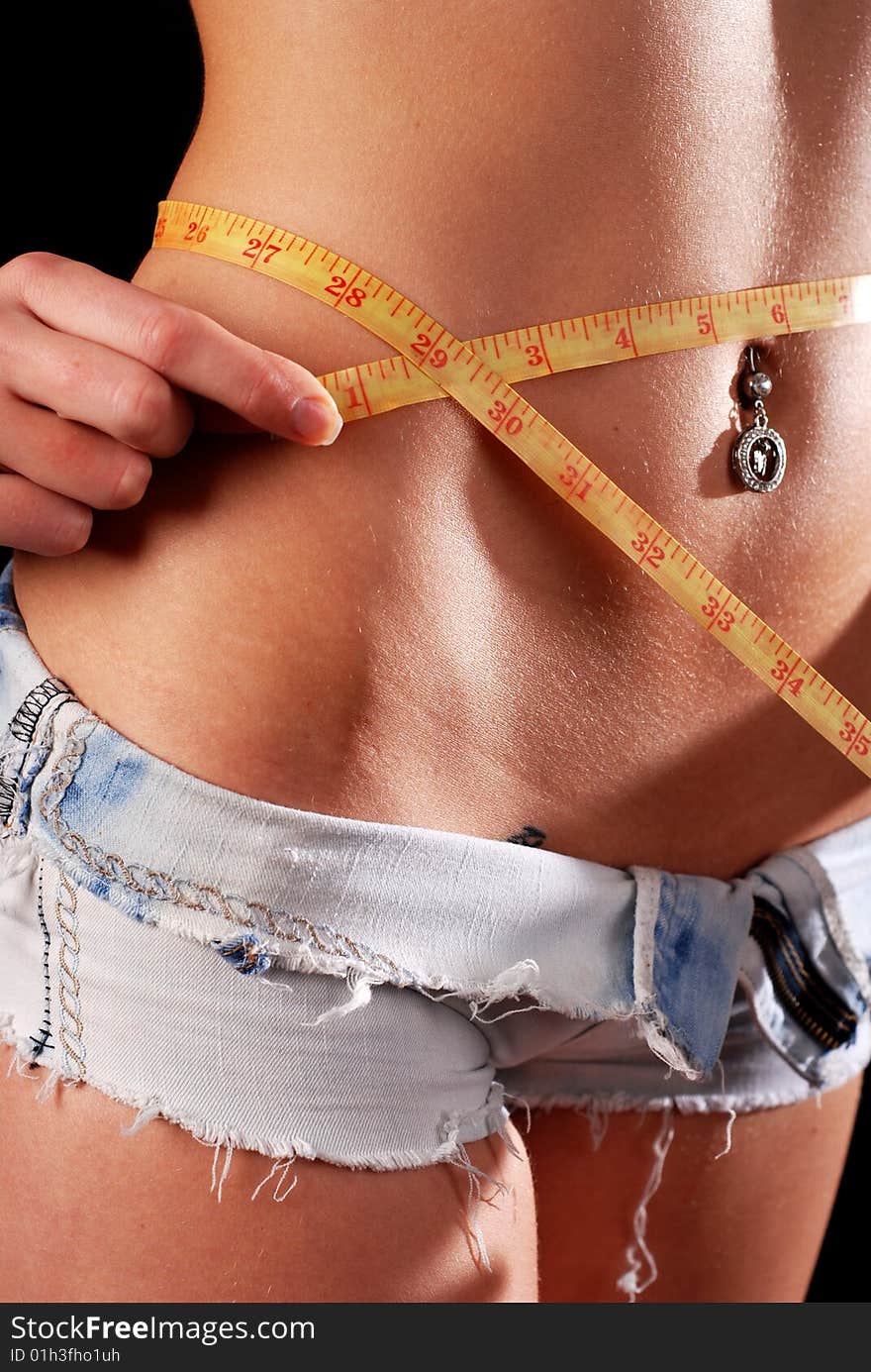 Waist of young woman with tape measure. Waist of young woman with tape measure