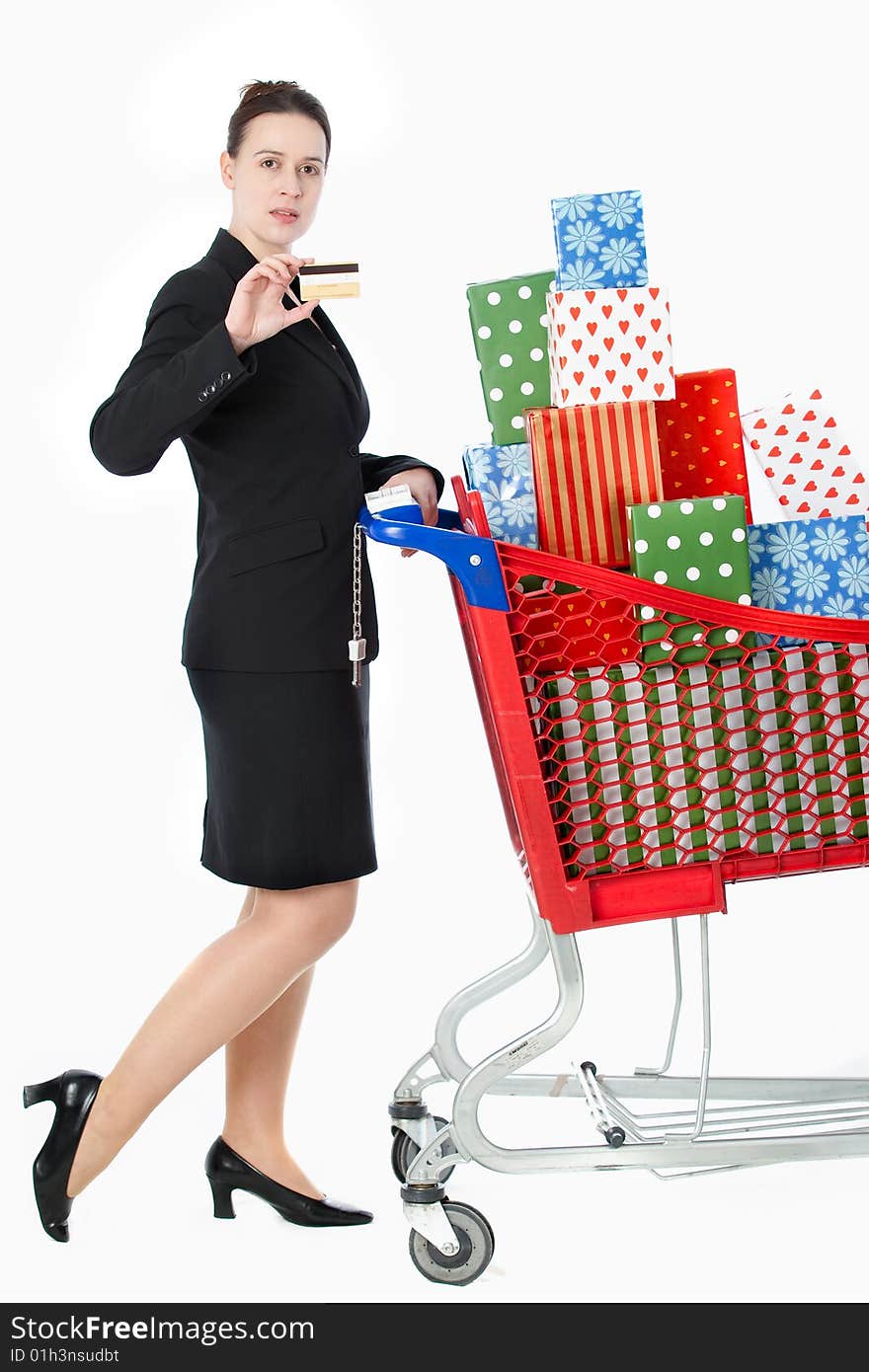 A smartly dressed woman shopping for gifts with a credit card on white. A smartly dressed woman shopping for gifts with a credit card on white