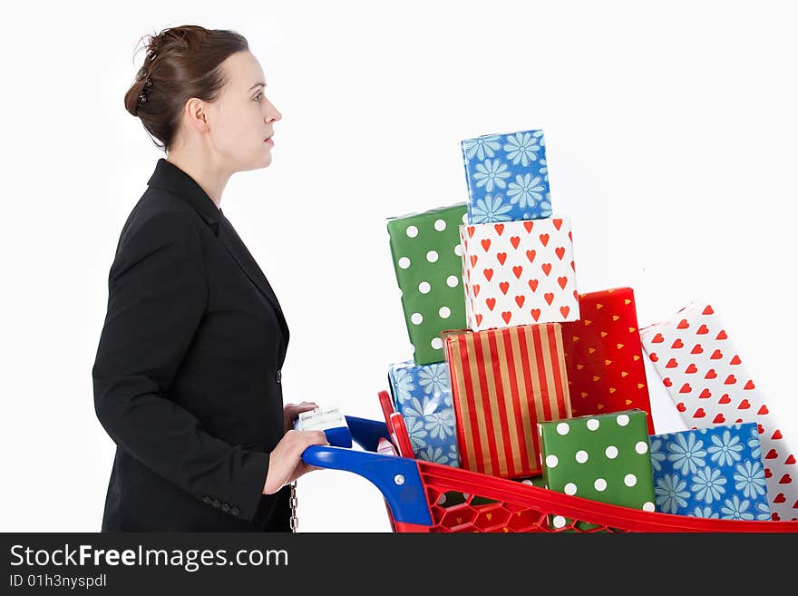 A smartly dressed woman shopping for gifts with a shopping cart. A smartly dressed woman shopping for gifts with a shopping cart