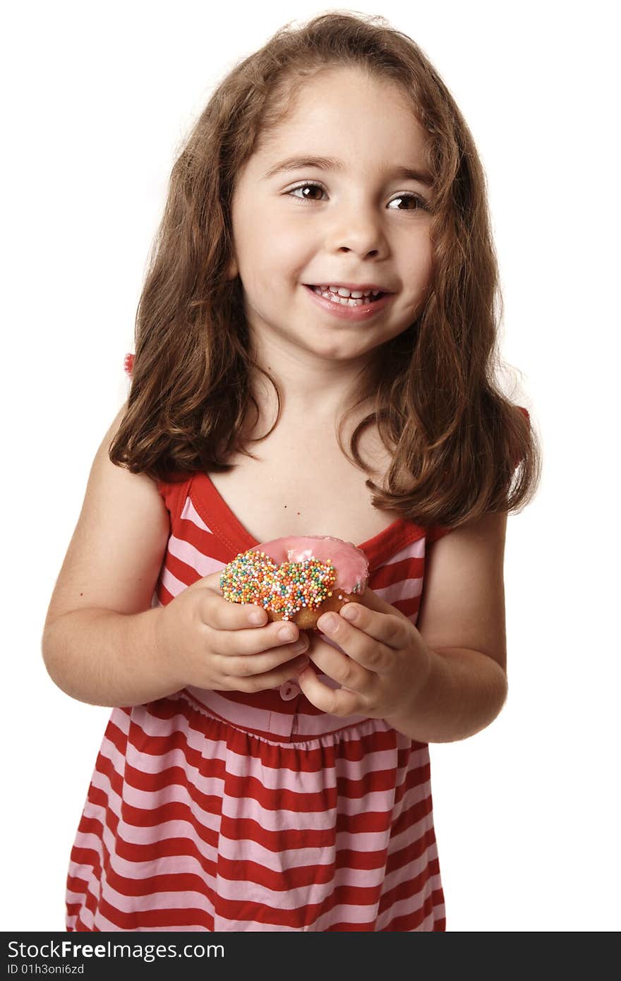 Smiling girl wearing a red striped dress is holding an iced pink doughnut. Smiling girl wearing a red striped dress is holding an iced pink doughnut.